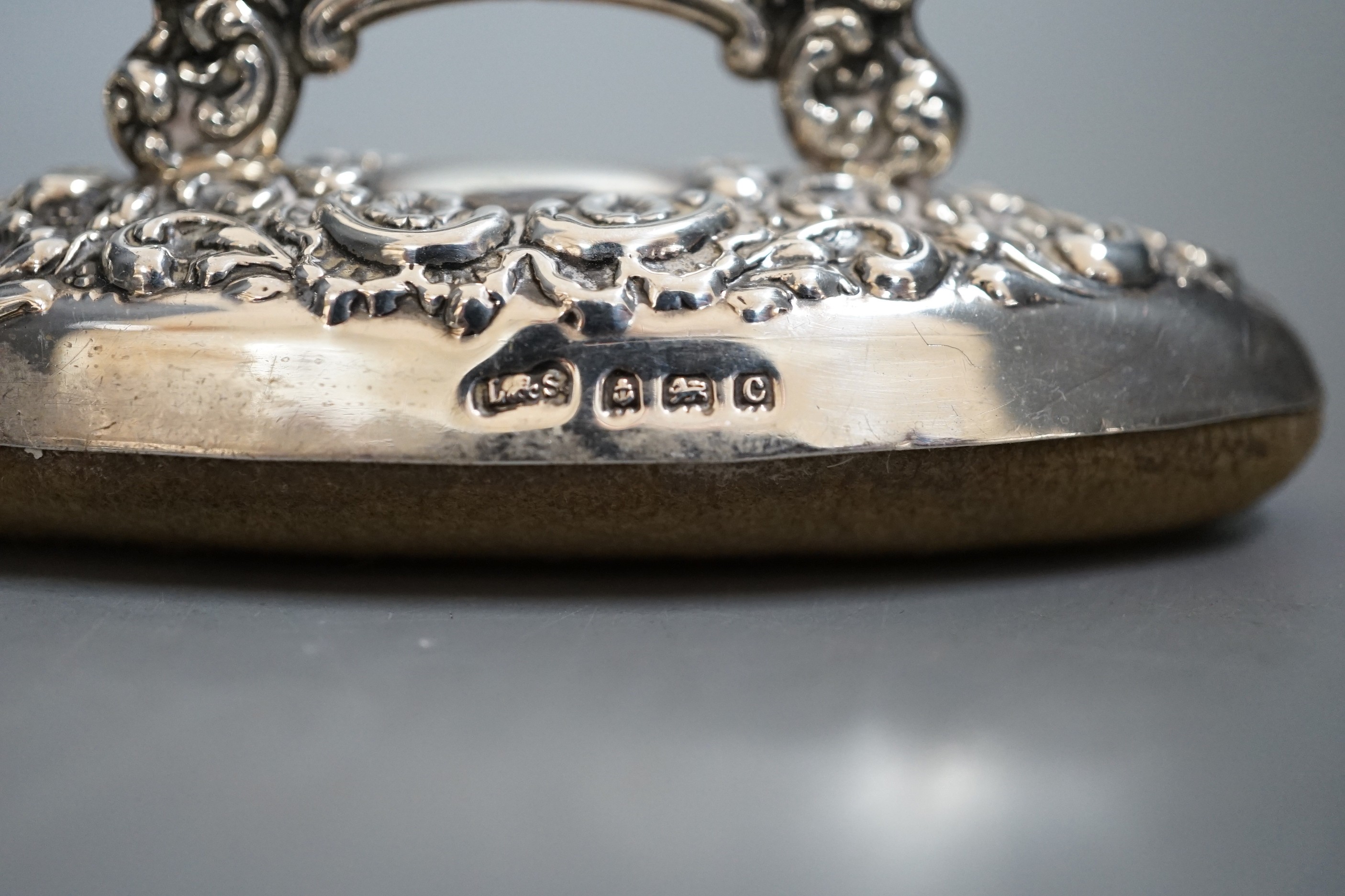 An Edwardian miniature silver-cased mantel timepiece, snuff box, blotter, clover-shaped dish and silver-capped glass jar.